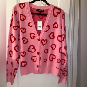 Cute valentine cardigan. size medium. Never worn. Excellent condition.